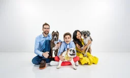 family photo including a man, woman, son, and three dogs